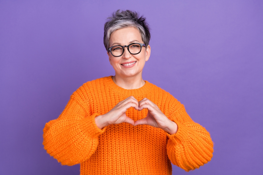 Jane, a bookkeeper, showing a love sign as she displays her love for how Gatheroo has helped her business